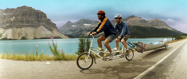 Brent and Gary on tandem bicycle towing canoe