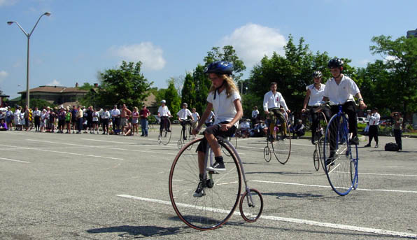 Children's formation riding on penny farthings