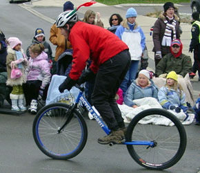 Oliver rides the Hulabike in the Santa Claus Parade