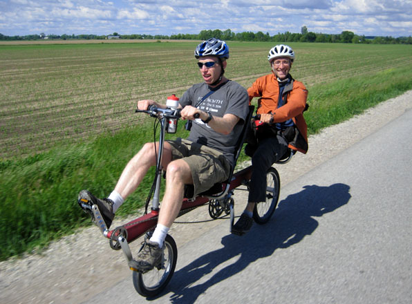 Brent and Boaz pedal the BikeE E2 recumbent tandem toward London